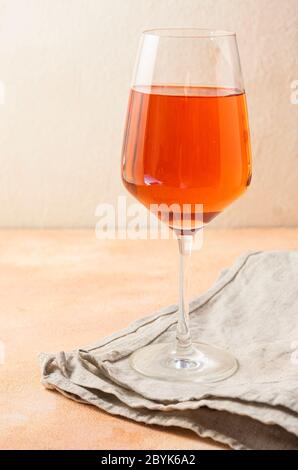 a tall, clear glass of rich orange wine. Alcoholic beverage Stock Photo