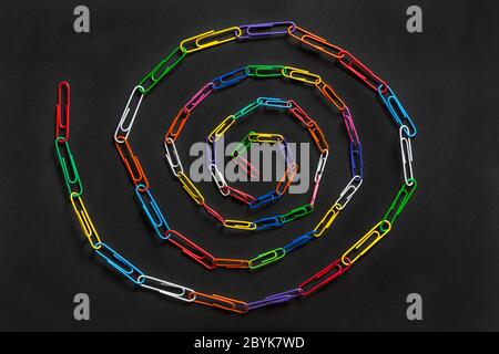 Paperclip chain spiral, Paperclips chain spiral, isolated on black background - paper clips, paper clip abstract Stock Photo