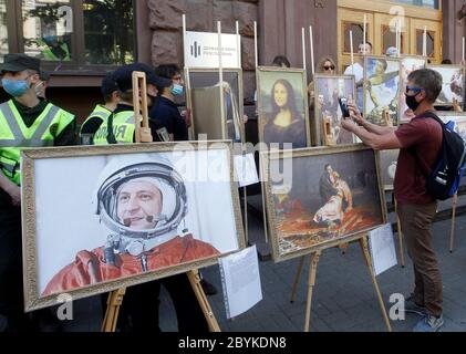 June 10, 2020, Kiev, Ukraine: A painting depicting Ukrainian President Volodymyr Zelensky (L) is seen during a symbolic exhibition at a protest of supporters of former Ukrainian President Petro Poroshenko in front the State Bureau of Investigation in Kiev, Ukraine, on 10 June 2020. Former Ukrainian President Petro Poroshenko arrived the State Bureau of Investigation for questioning as a witness in criminal cases. Poroshenko was called for questioning to the State Bureau of Investigation as a witness in the case of alleged illegal movement across the border 43 paintings by famous artists and ot Stock Photo
