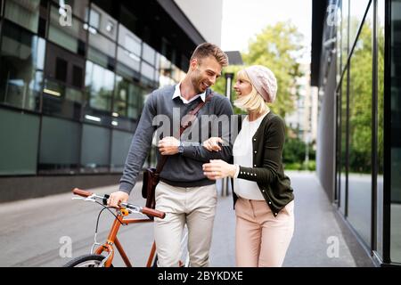 Beautiful happy couple in love on bicycle in the city having fun Stock Photo