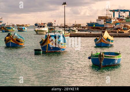 Colorful Boats at fishing port in Marsaxlokk, in the southeast of Malta. There are ports large and imposing like that of the capital Valetta, but small fishing ports characterize the varied coast of Malta and Gozo
