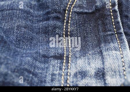 Macro close up of isolated blue casual denim jeans pants zipper compartment with yellow stitches (focus on centre) Stock Photo