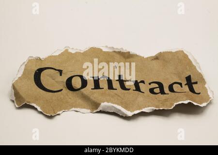 Cancelled agreement concept: Close up of isolated crumpled piece of scrap paper with word contract, white background Stock Photo