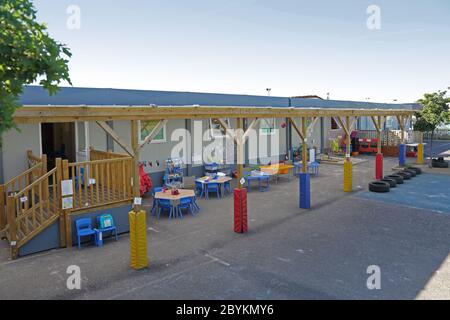 Temporary classrooms erected in the playground  of a London junior school, UK. Built from modular units and featuring a covered outdoor play area. Stock Photo