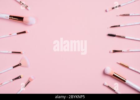 Flat lay composition with make up brushes on pink background. Makeup store banner mockup. Stock Photo