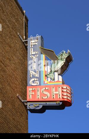 LITTLE ROCK, ARKANSAS, USA - JULY 25, 2019: Flying Fish nostalgic neon sign. Vintage advertising sign on the street for Cajun seafood restaurant. Stock Photo