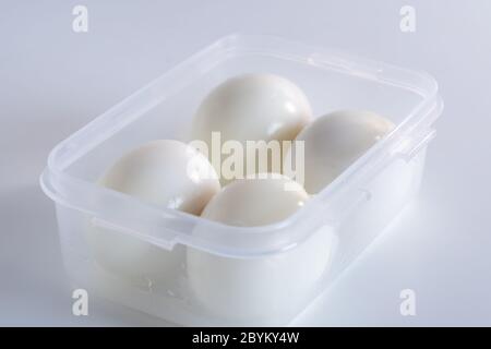 Peeled boiled chicken eggs in a plastic container Stock Photo