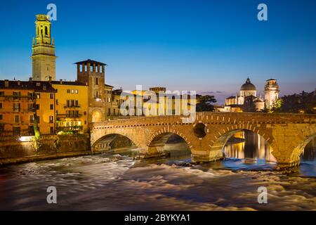 Ponte Pietra over River Adige with Cathedral Anastasia and the skyline of Verona beyond, Veneto, Italy Stock Photo