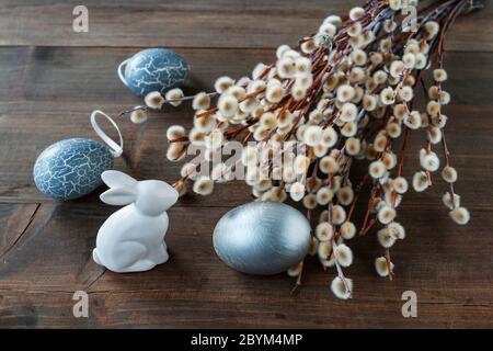 Bunch of catkins and Easter eggs on wooden table. Festive decor Stock Photo