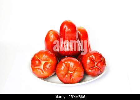 red fruit, rose apples or chompoo isolated in plate on white background Stock Photo