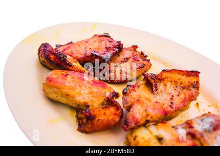 tasty grilled fried pork in plate isolated on white background Stock Photo