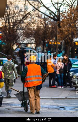 Back view of construction worker wearing reflective vest preparing for work. Bucharest, Romania, 2020 Stock Photo