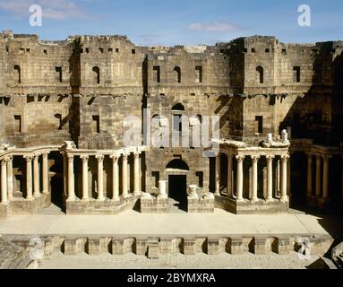 Syria. Bosra. Roman Theatre. Constructed using black basalt. 2nd century AD, during the reign of Trajan. View of the stage (Scaenae frons, porticus post scaenam, pulpitum). Photo taken before the Syrian Civil War. Stock Photo