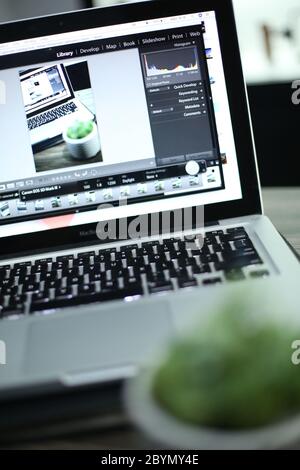 working with computer laptop, working with photo editing software Stock Photo