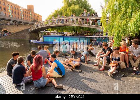 Young people socialising beside the Regent's Canal in Camden Town, London, UK Stock Photo