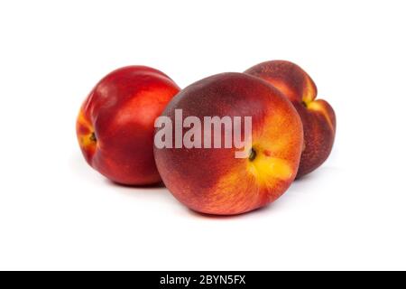 Three fresh nectarines on white Stock Photo