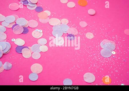 Colorful confetti, sparkles on bright pink background. Festive background. Stock Photo