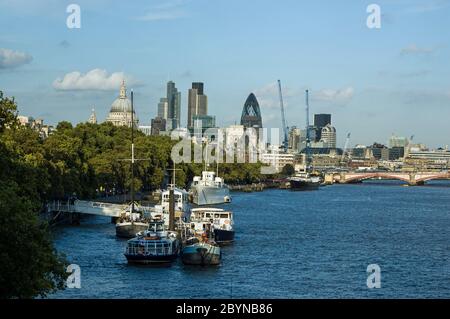 The tall office buildings of the City of London financial district, with the dome of St Paul's Cathedral as seen from Waterloo Bridge over the River T Stock Photo