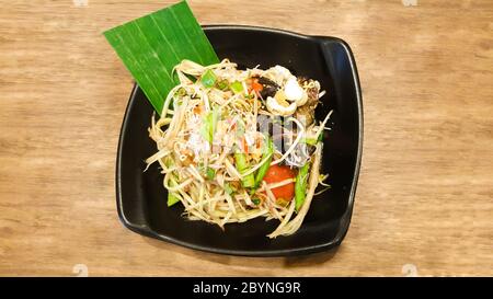 papaya salad with vermicelli and salted crab on black dish Stock Photo