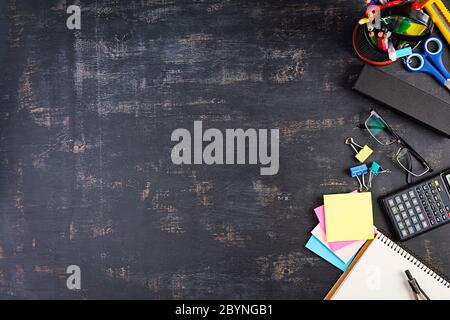 Different school supplies on dark background. Concept Back to school Stock Photo