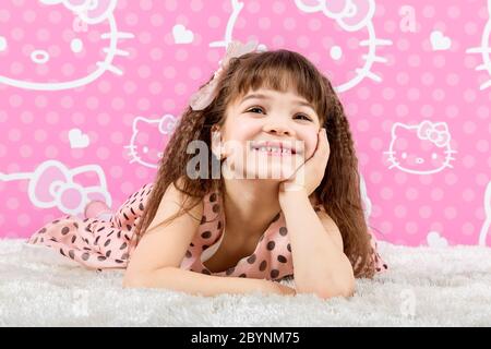 Little cute girl is on the fur carpet Stock Photo