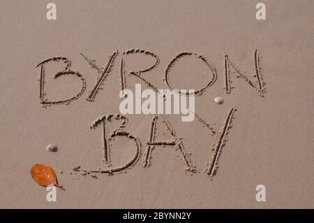 Byron Bay inscription drawn in the sand. Byron Bay is one of the most famous tourist spot in Australia, known for his chilled vibes, surfing and the a Stock Photo