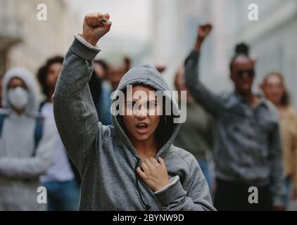 Group of activists giving slogans in a protest march. Youngsters protesting for protection of civil rights. Stock Photo
