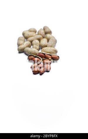 Close up view of shelled peanuts and cracked peanuts isolated on white background Stock Photo
