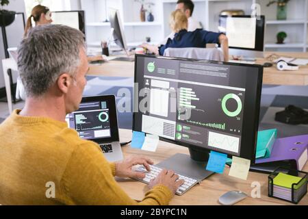 Caucasian senior businessman working on computer Stock Photo