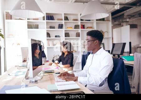 Mixed race businesspeople in workspace Stock Photo