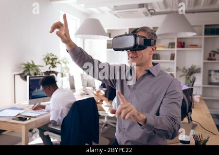 Caucasian businessman testing VR at work Stock Photo
