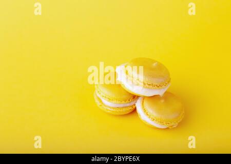 Three yellow lemon macaroon in pile on yellow background Stock Photo