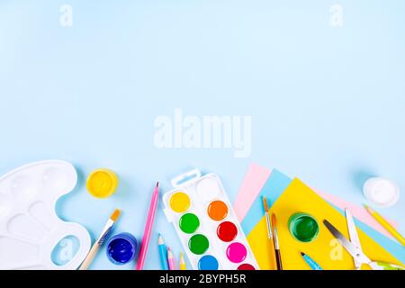 Various school office and painting supplies on blue background. Back to school concept. Top view. Copy space Stock Photo