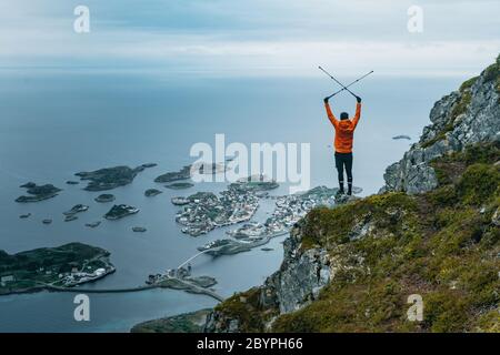 Hiker on rocky trail walking on mountain ridge. Concept vision. On top of peak mountain and looking forwards, success, competition and leader concept. Stock Photo