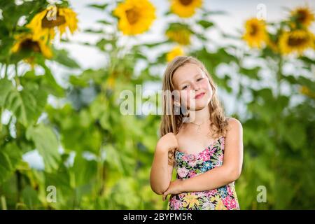 Portrait of a little girl in wreath of flowers Stock Photo