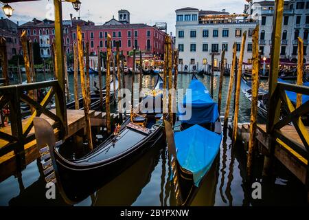 Two traditional Grand Canal gondolas moored to pier, Venice, Italy