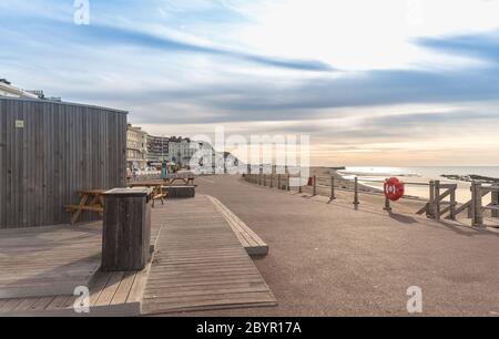 Promenade by Hastings shore with blue sky during evening. Stock Photo