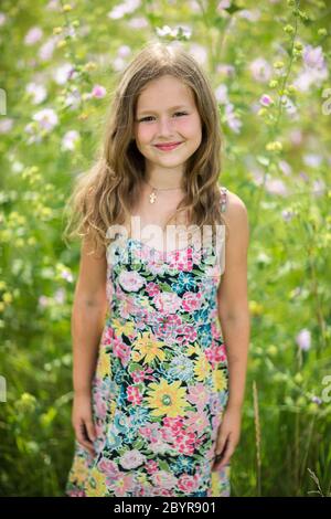 Portrait of a little girl in wreath of flowers Stock Photo
