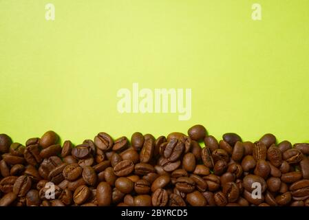 Texture of coffee beans. Roasted coffee beans background. close up Coffee beans with copy space on green background Stock Photo