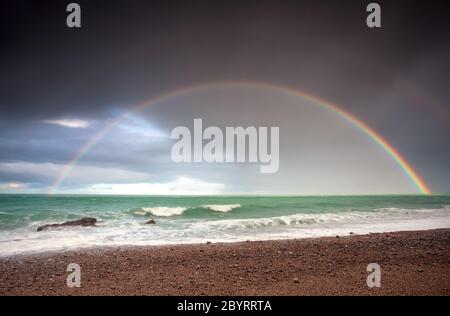 double rainbow over ocean coast Stock Photo