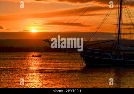 Sunset and sailboat mast in Ortigia, Syracuse, Sicily, Italy Stock Photo