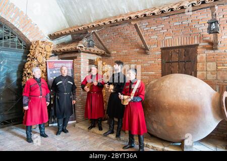 Kakheti, Georgia - October 2019: Georgian folk musicians performing at Khareba Winery. Khareba is a popular winery for tourists Stock Photo
