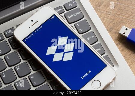 Dropbox mobile app welcome screen is seen on a iPhone. Stock Photo