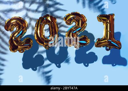 Golden Christmas Balls 2021. With shadows on a blue background. New Year concept. Party decoration, anniversary sign for holidays, celebration, carnival Stock Photo