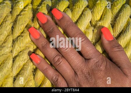 womans hand on mooring rope background Stock Photo