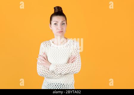 girl folded her arms over her chest and looks with astonished indignation Stock Photo