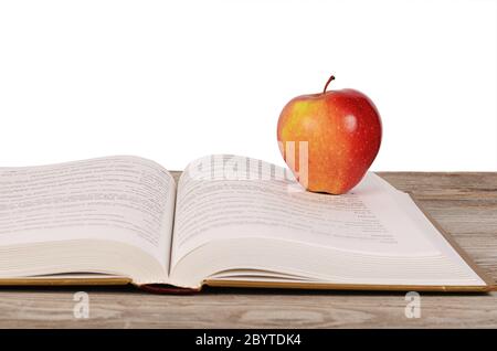 Open book with apple isolated on white background Stock Photo