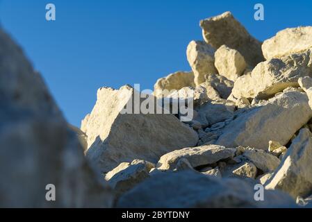 Stack of limestone. big crushed limestone stone. broken sandstone close-up. selective focus. Stock Photo