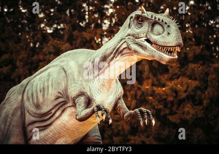 Realistic model of dinosaur in forest Stock Photo