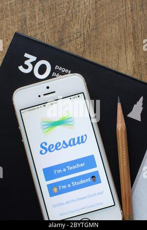 Seesaw mobile app login page seen on an iPhone. Seesaw is a platform for student driven digital portfolios and parent communication. Stock Photo